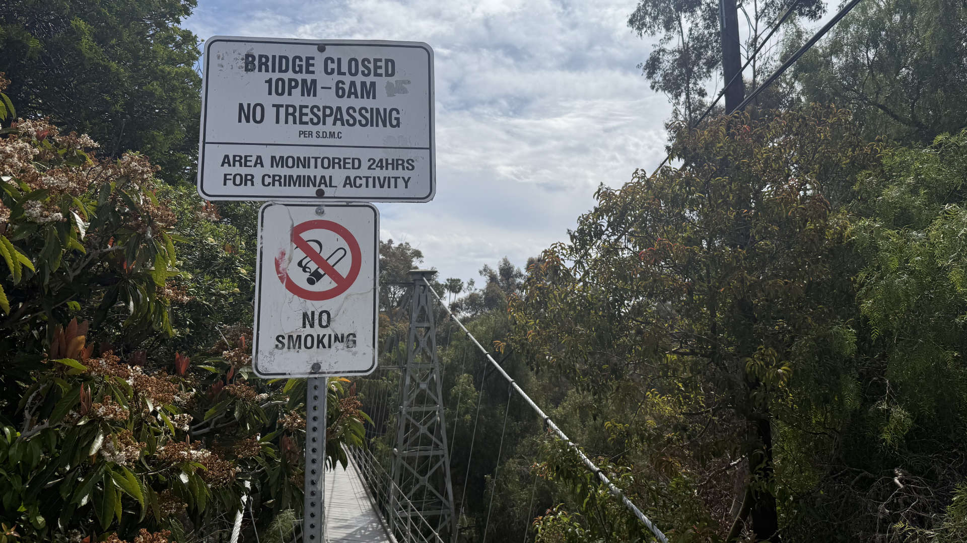 Official sign showing bridge hours: 6:00 AM to 10:00 PM daily